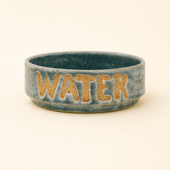 Ceramic water bowl with 'WATER' text on a beige background